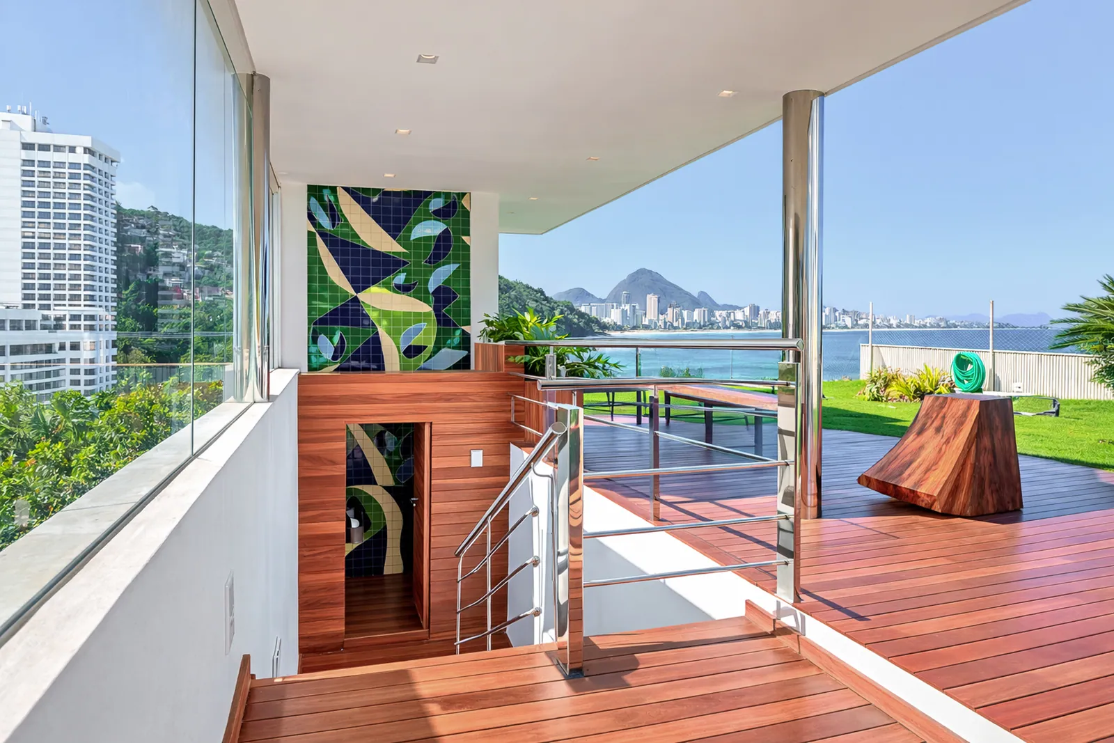 Glass, mosaic and decking, the coastline in the distance