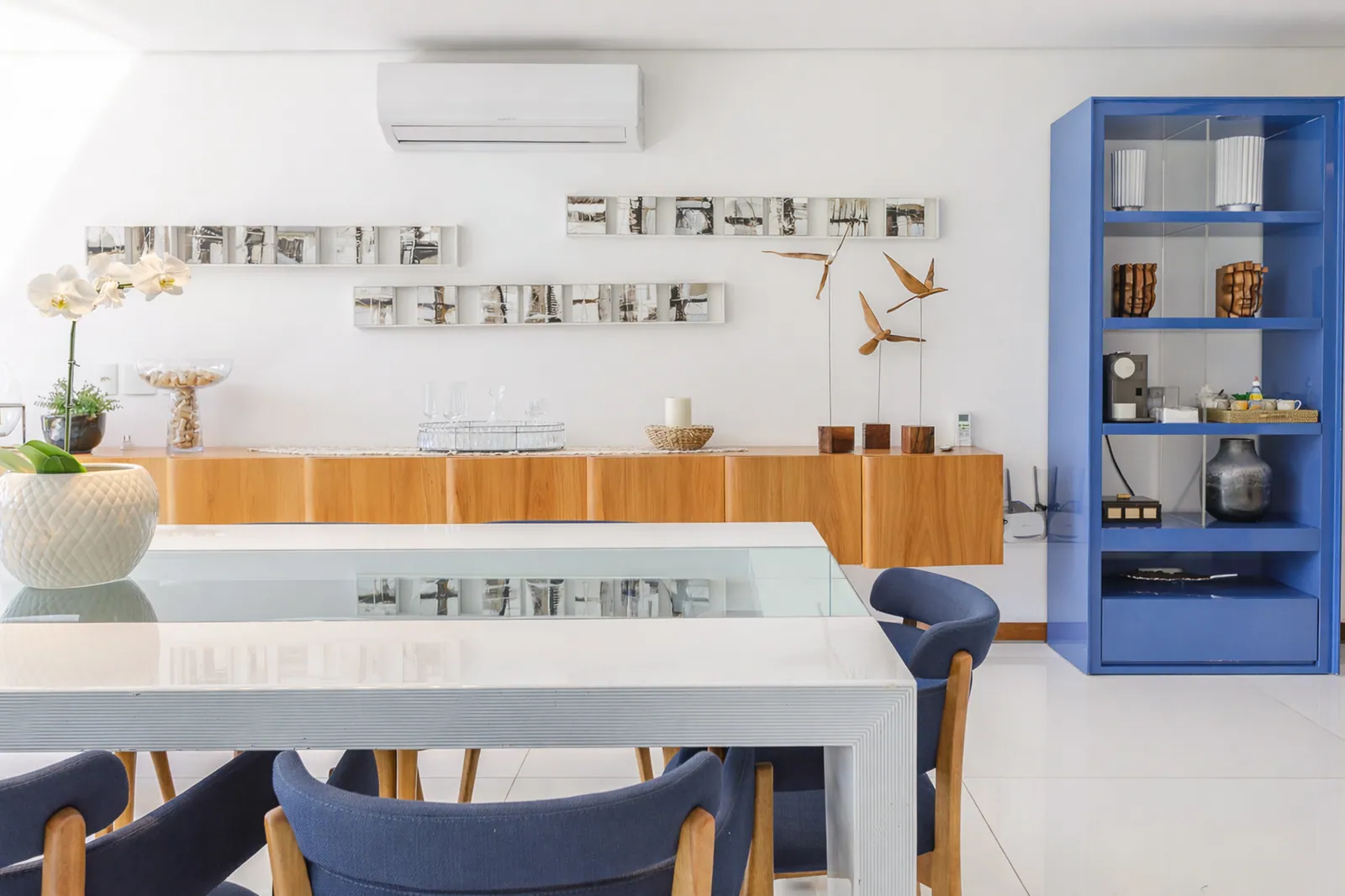 Dining area with blue shelving and white table