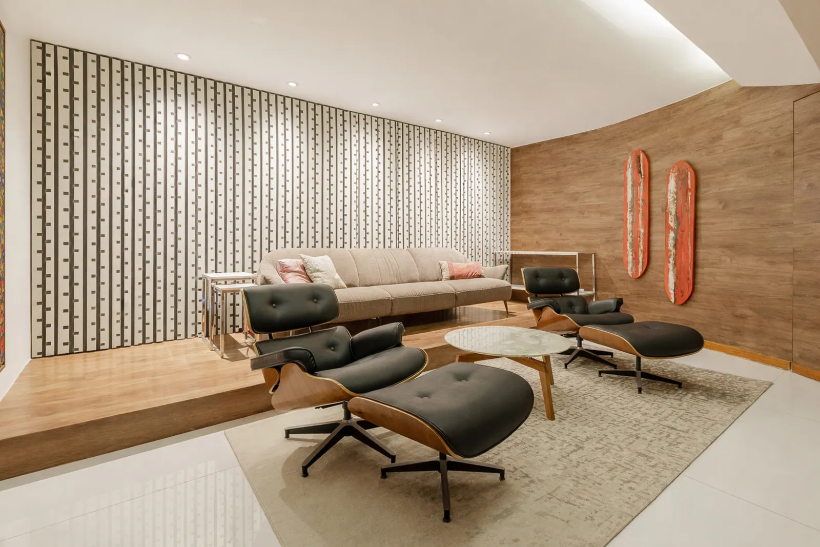 The screening room from the back, sofa and loungers on the rug
