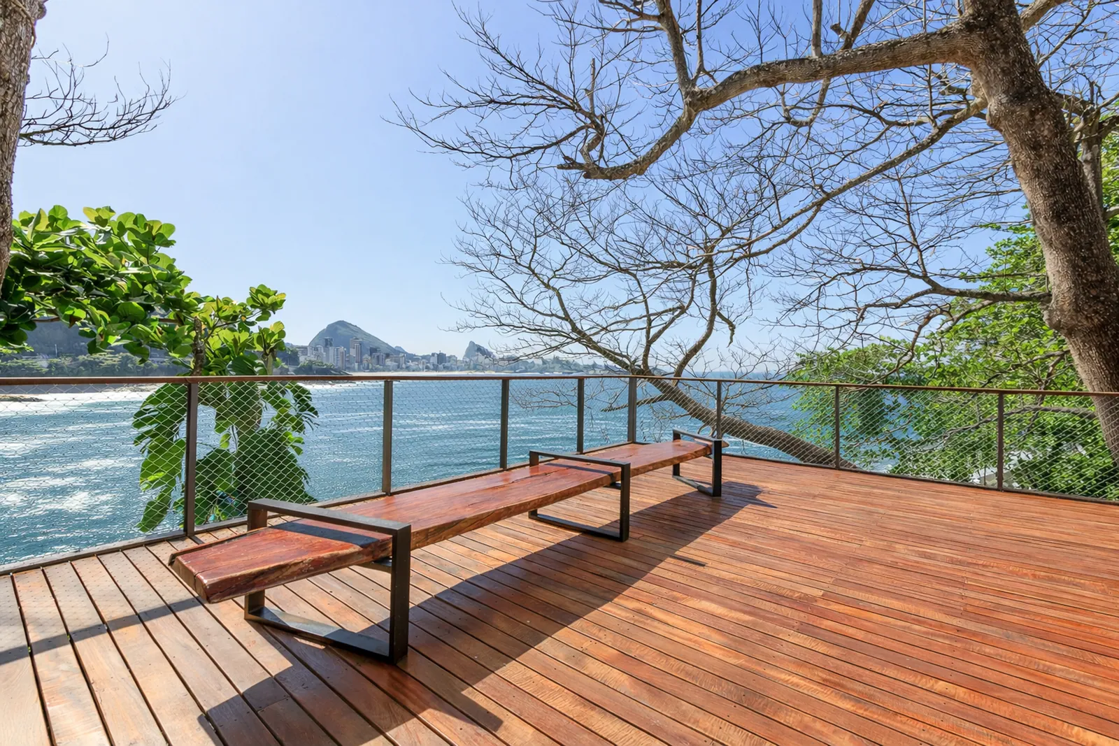 The lower deck at the water's edge, a bench facing the sea