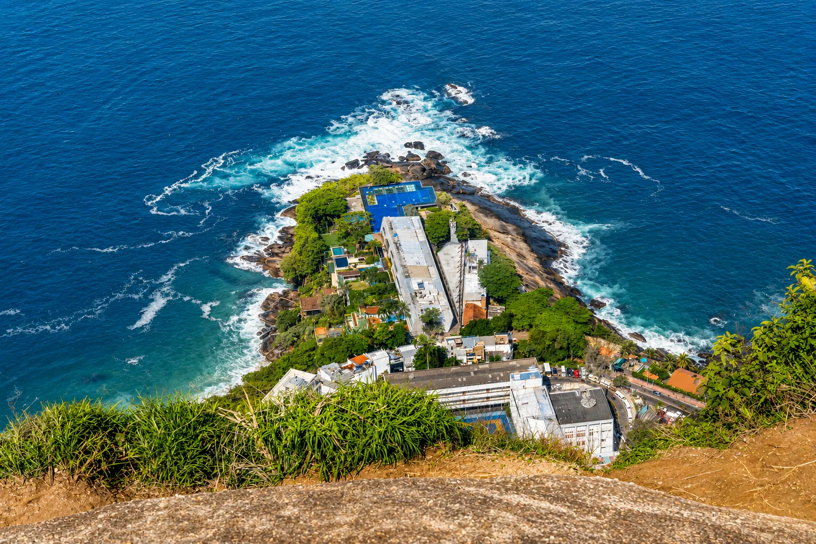 The headland and its houses seen from above, the Atlantic all around