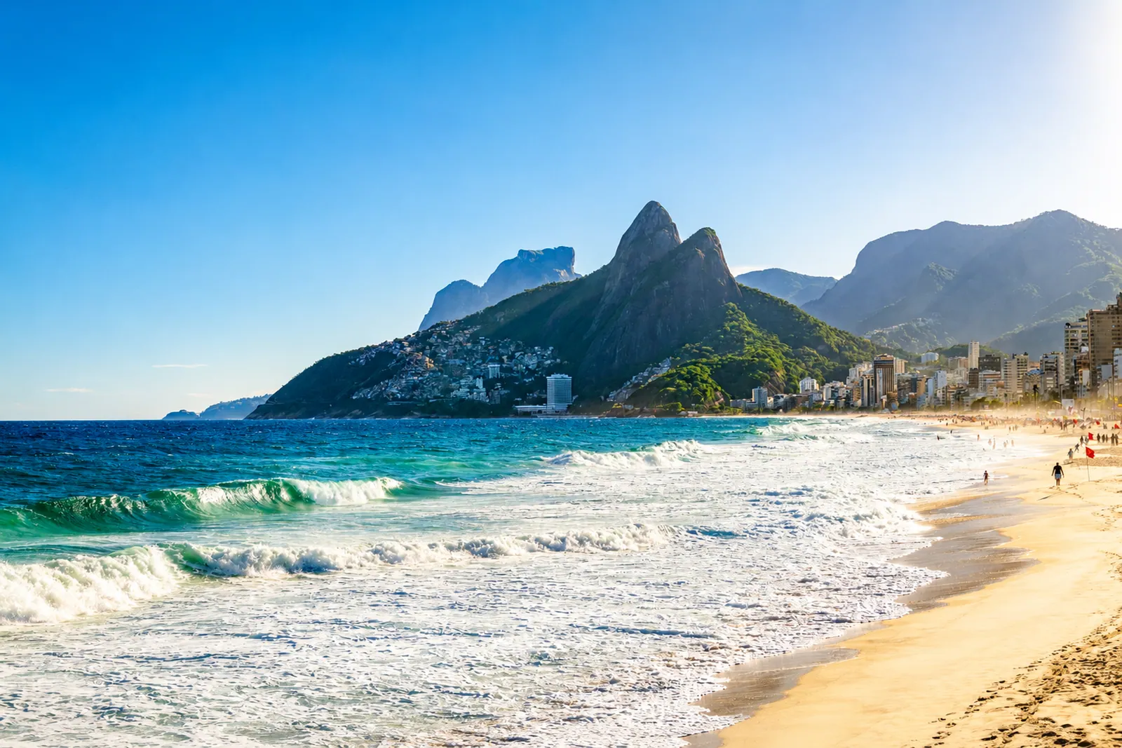 The Dois Irmãos above the beach, surf breaking below