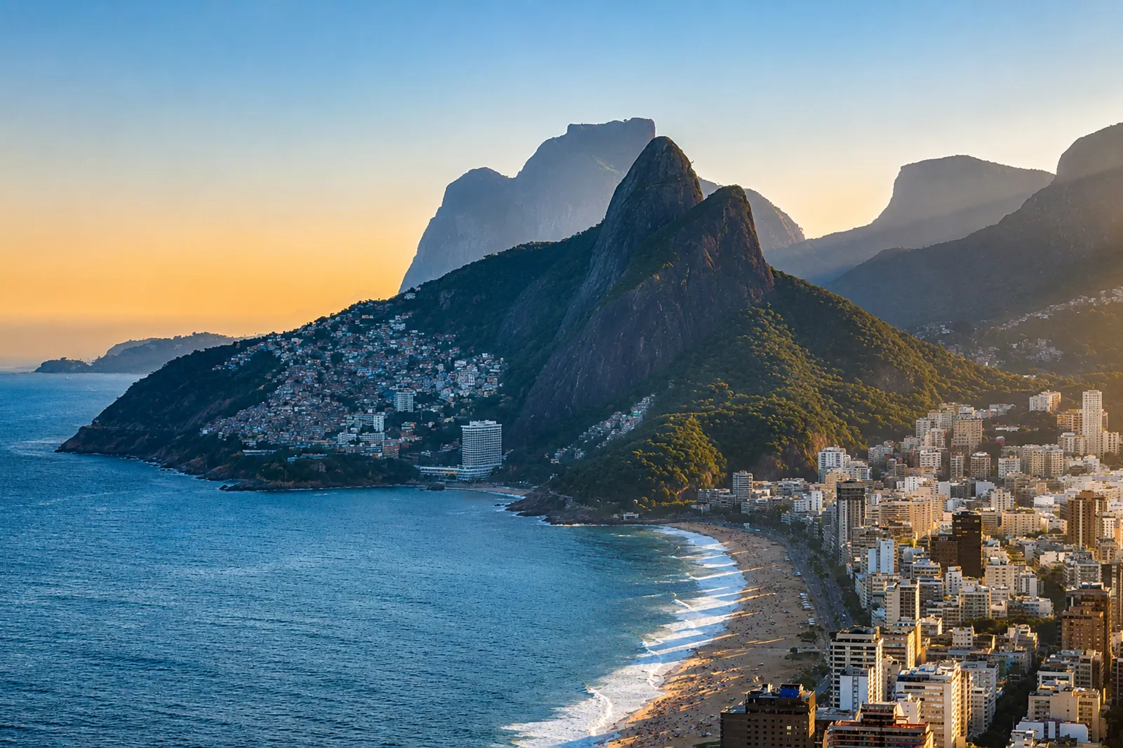 The Dois Irmãos at dusk, the bay turning gold