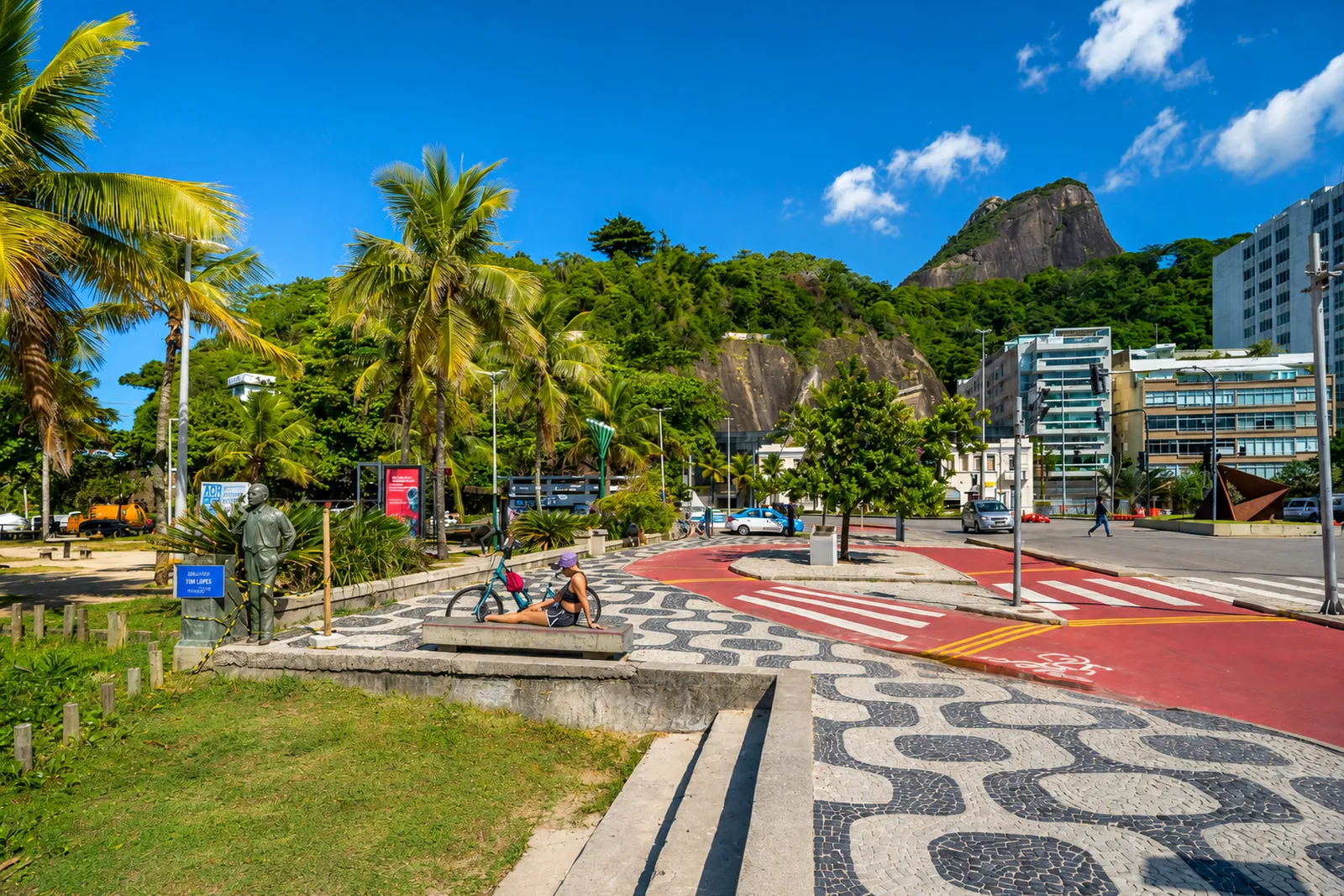 The wave-patterned promenade and its palms along the beach