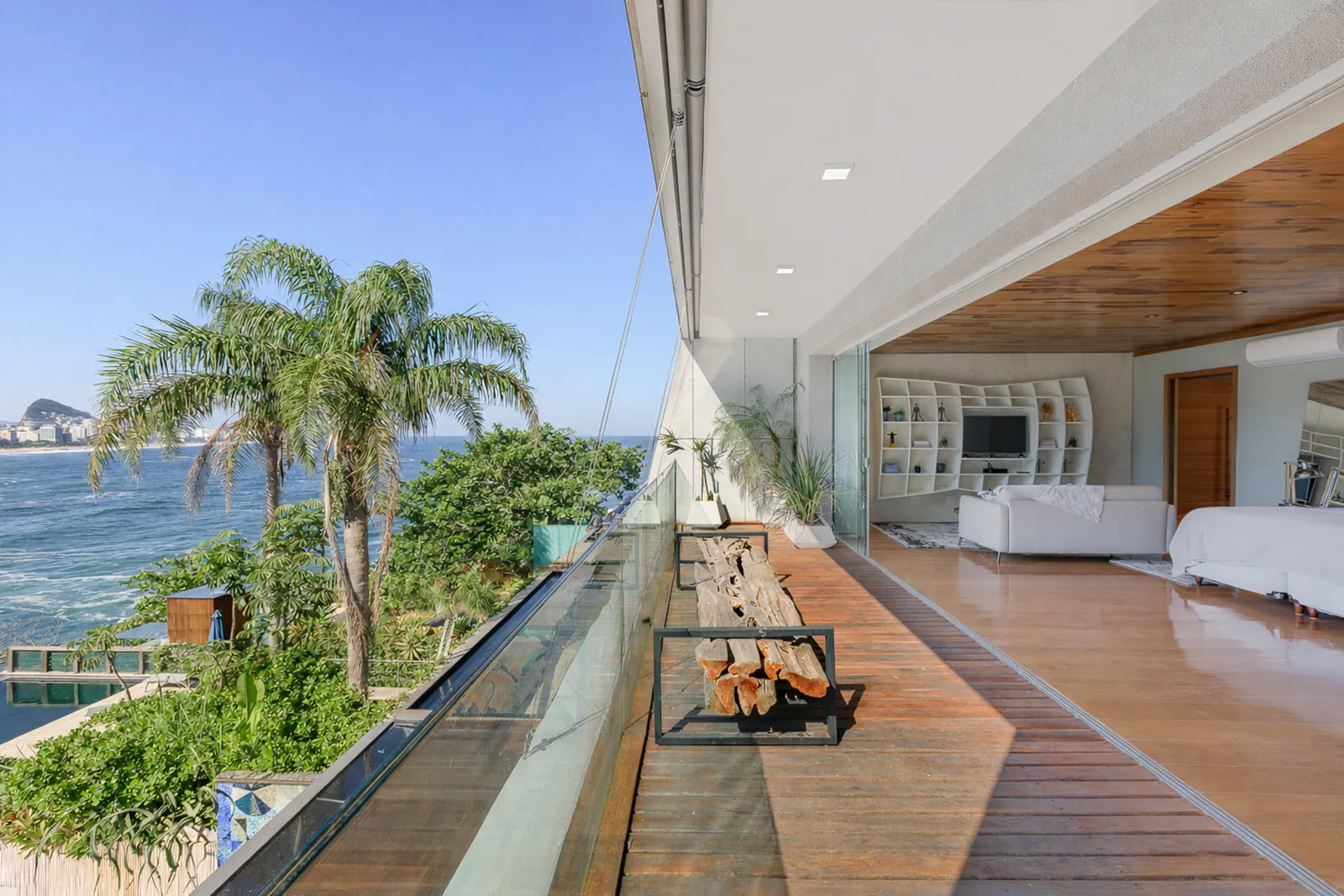 A walkway along the glass, the pool below and the ocean ahead