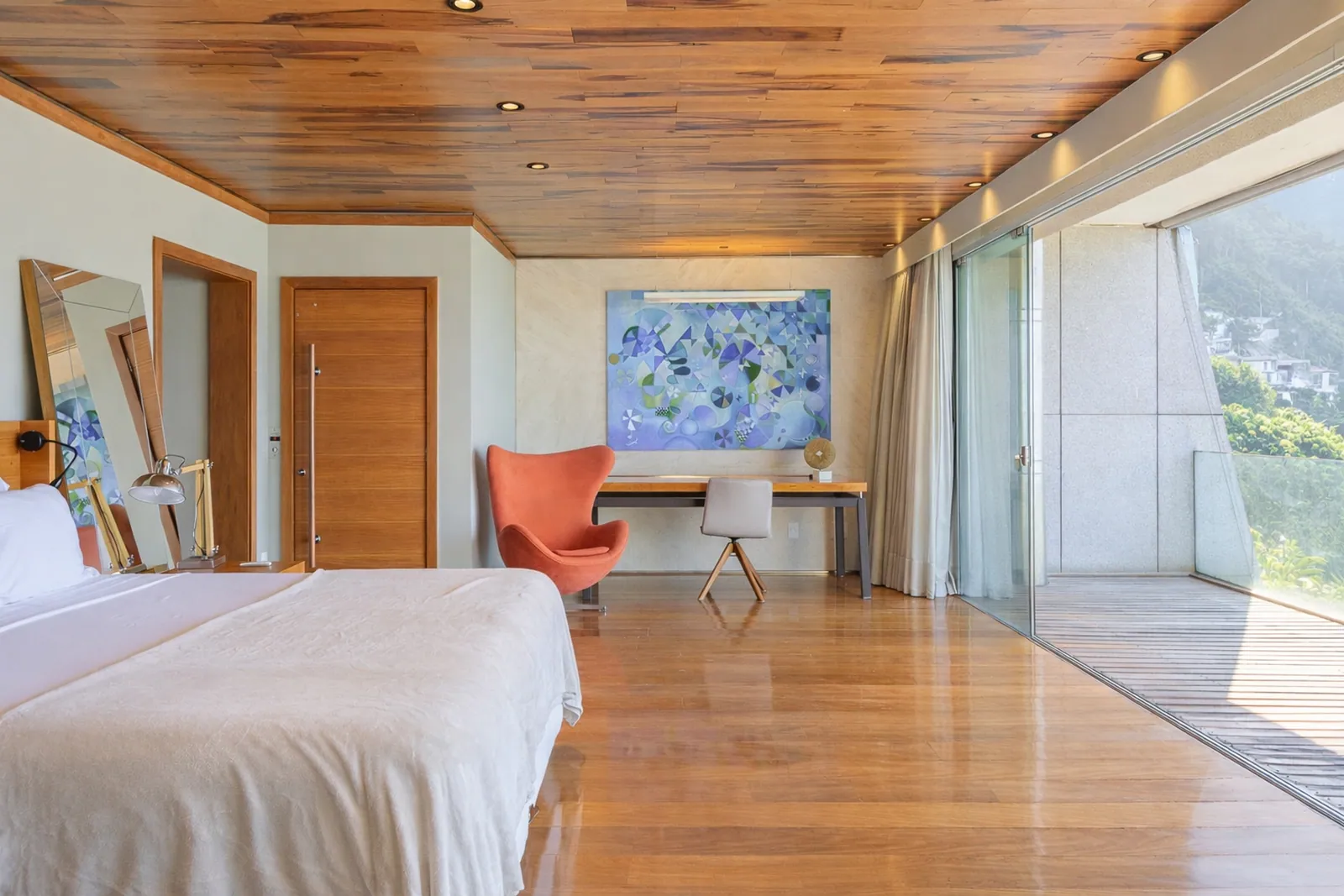 Bedroom with writing desk and armchair, wood ceiling above