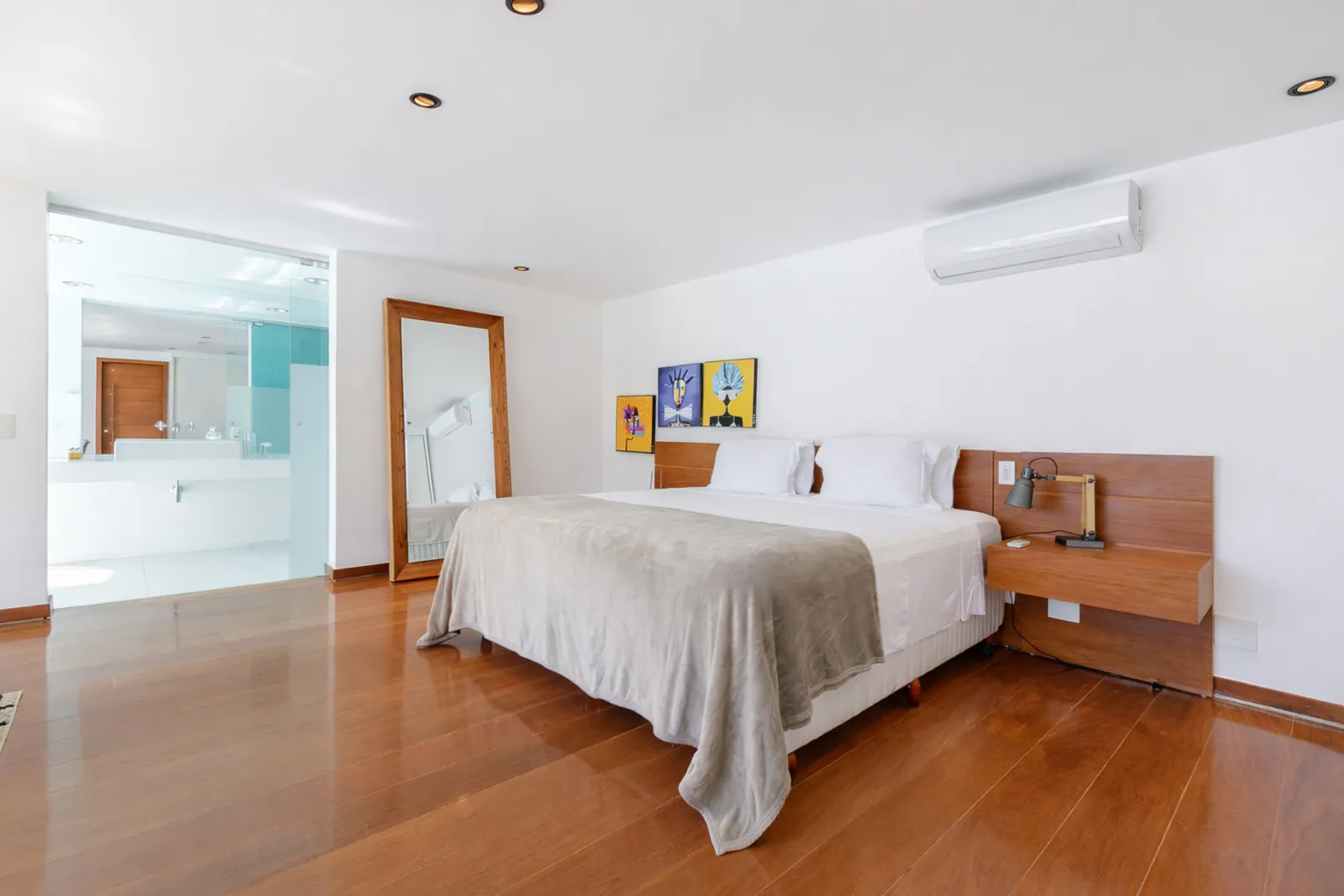 Bedroom with its bathroom open beyond the doorway