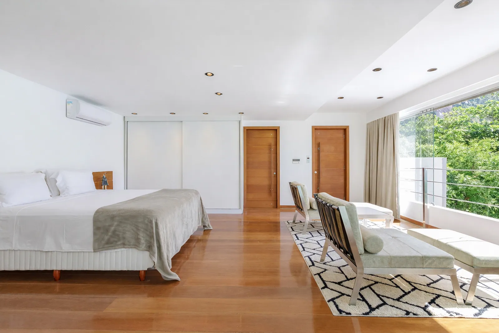 Bedroom with wood floor, light along the whole glass wall