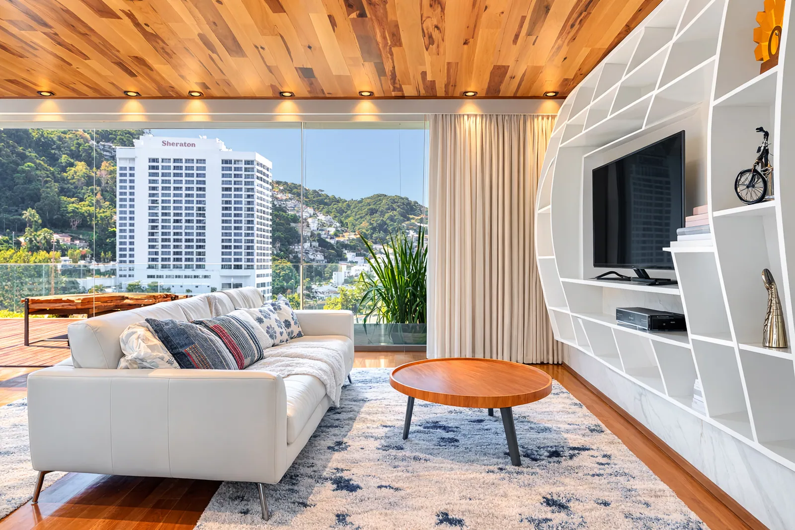 Television lounge under the wood ceiling, sea through the window